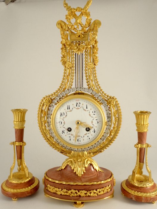 Antique French ormolu lyre clock garniture with swinging paste set